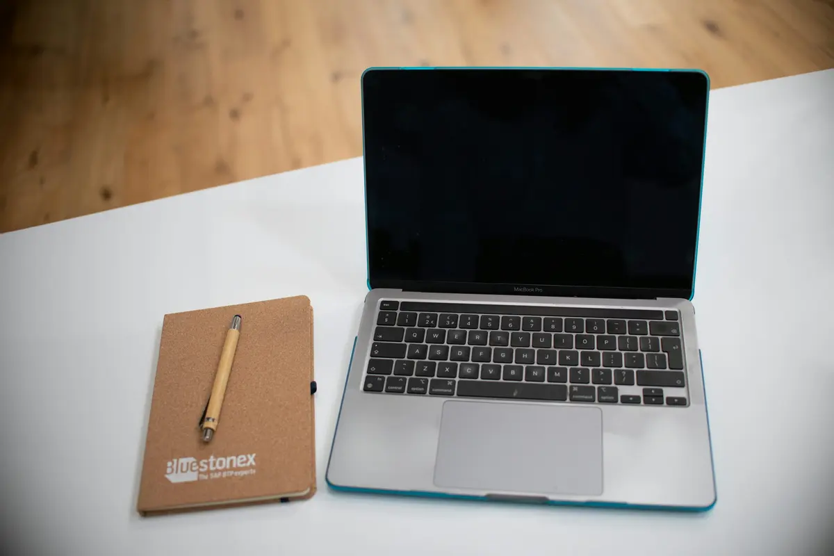 Laptop and notebook on a work desk