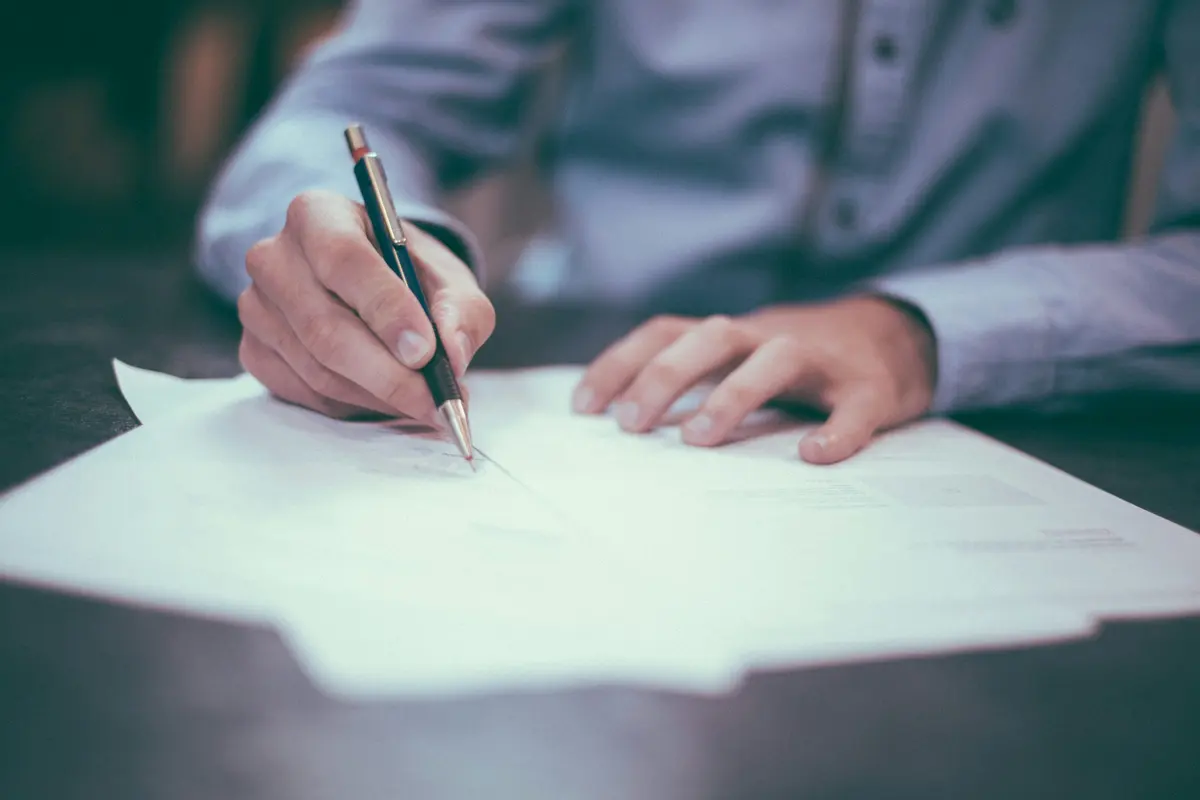 Hands completing a paper document