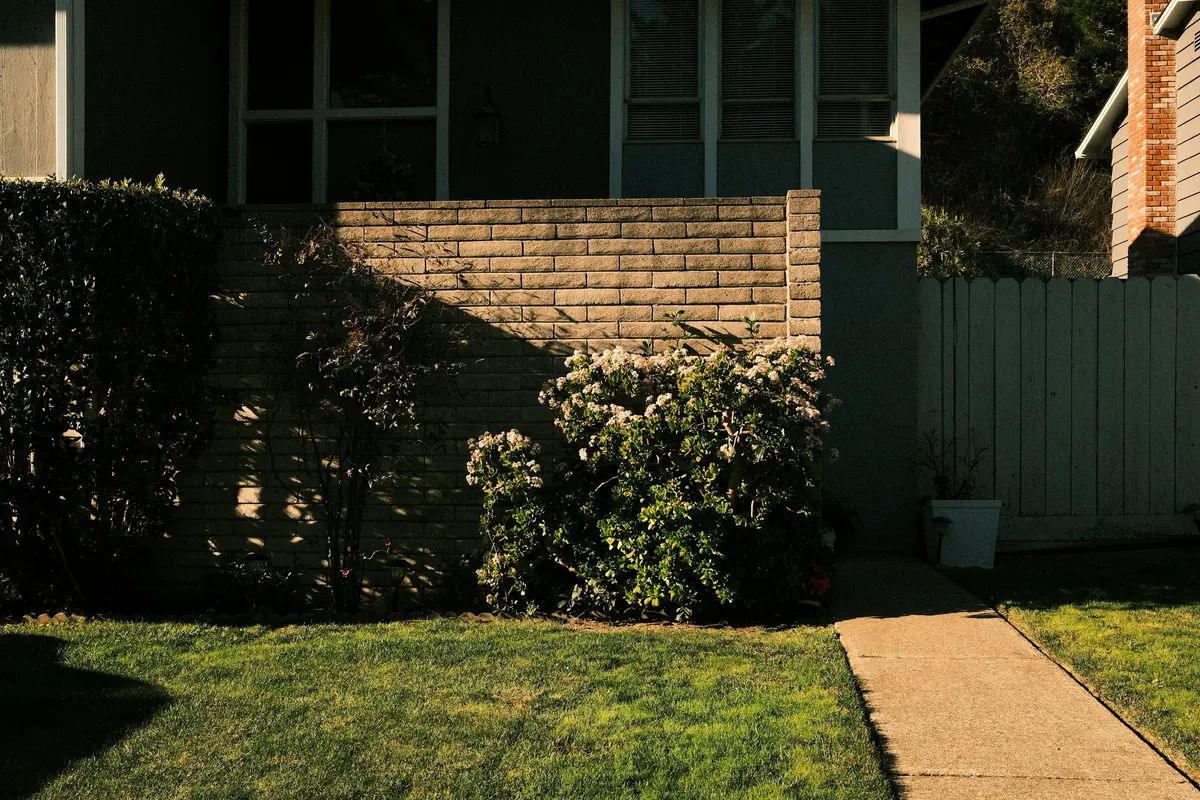 Suburban house with a walkway and green front lawn