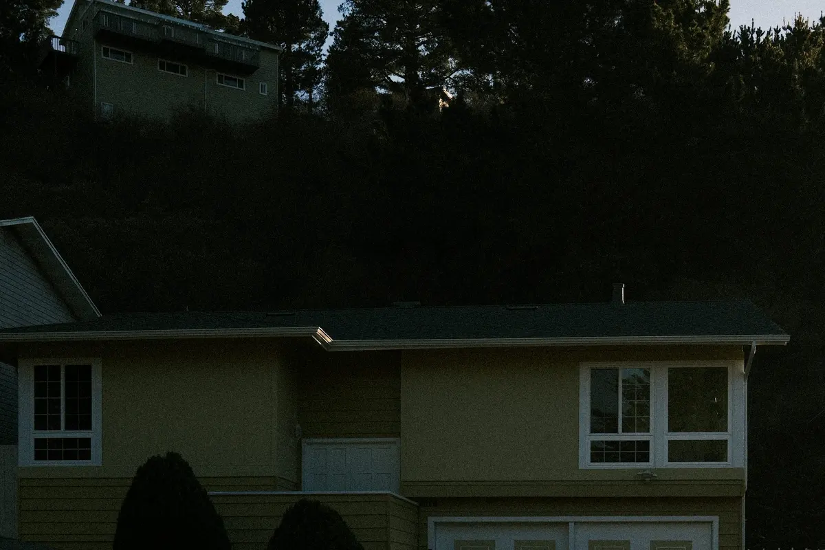 House facade with surrounding trees